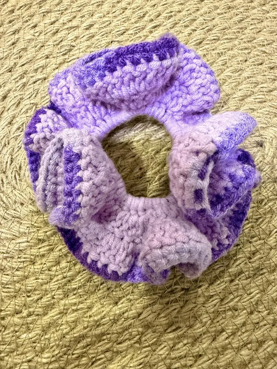 A handmade ruffle scrunchie in lavender and purple.