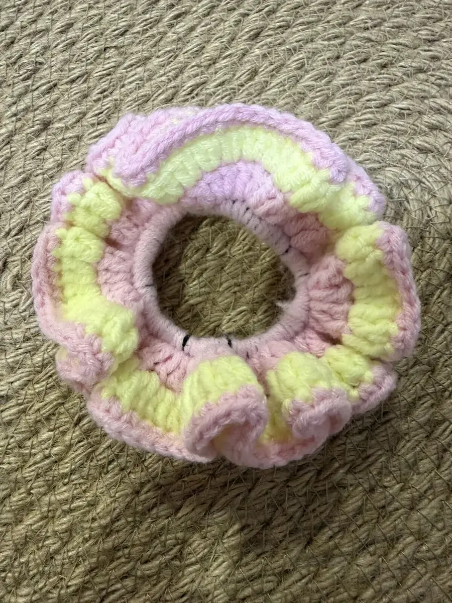 A handmade ruffle scrunchie in lilac with lime stripes.