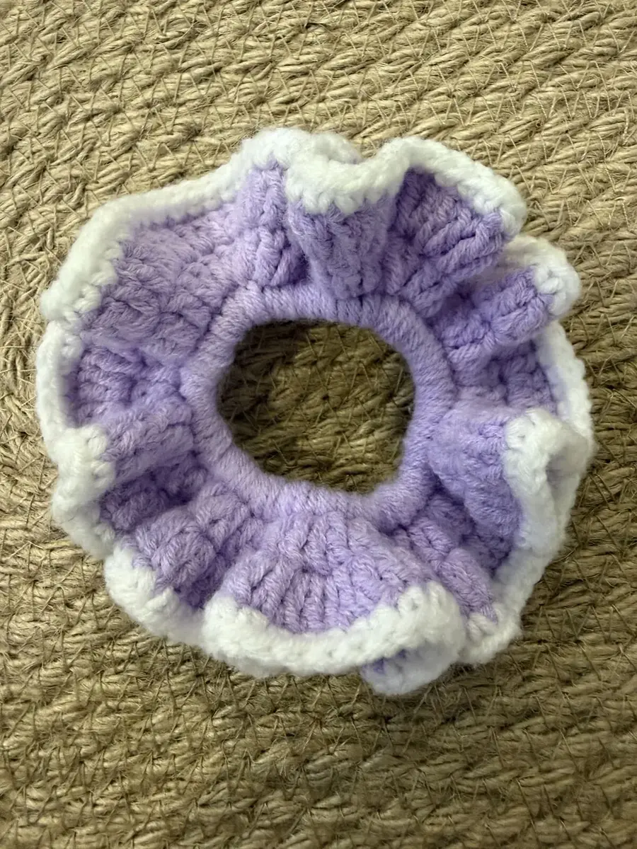 A handmade ruffle scrunchie in lilac with a cream edge.