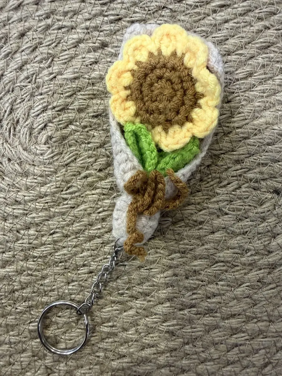 A mini crochet sunflower bouquet keychain.