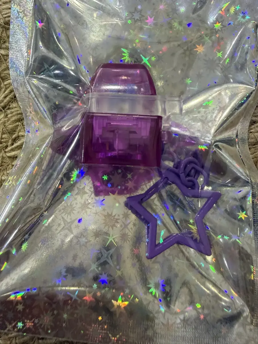 A single purple keycap clicker with a star charm.