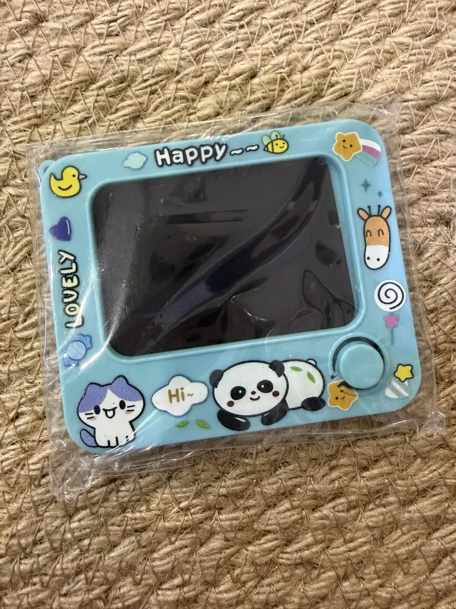 A mini writing board in a panda and cat frame that says Happy.