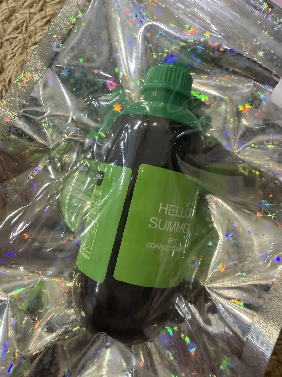 A bottle-shaped correction tape, Hello Summer, in a holographic bag.